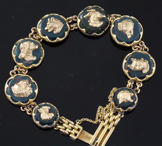 An early 20th century 9ct gold and bloodstone panel set bracelet, each stone with a gold dogs head applique, gross 19 grams.